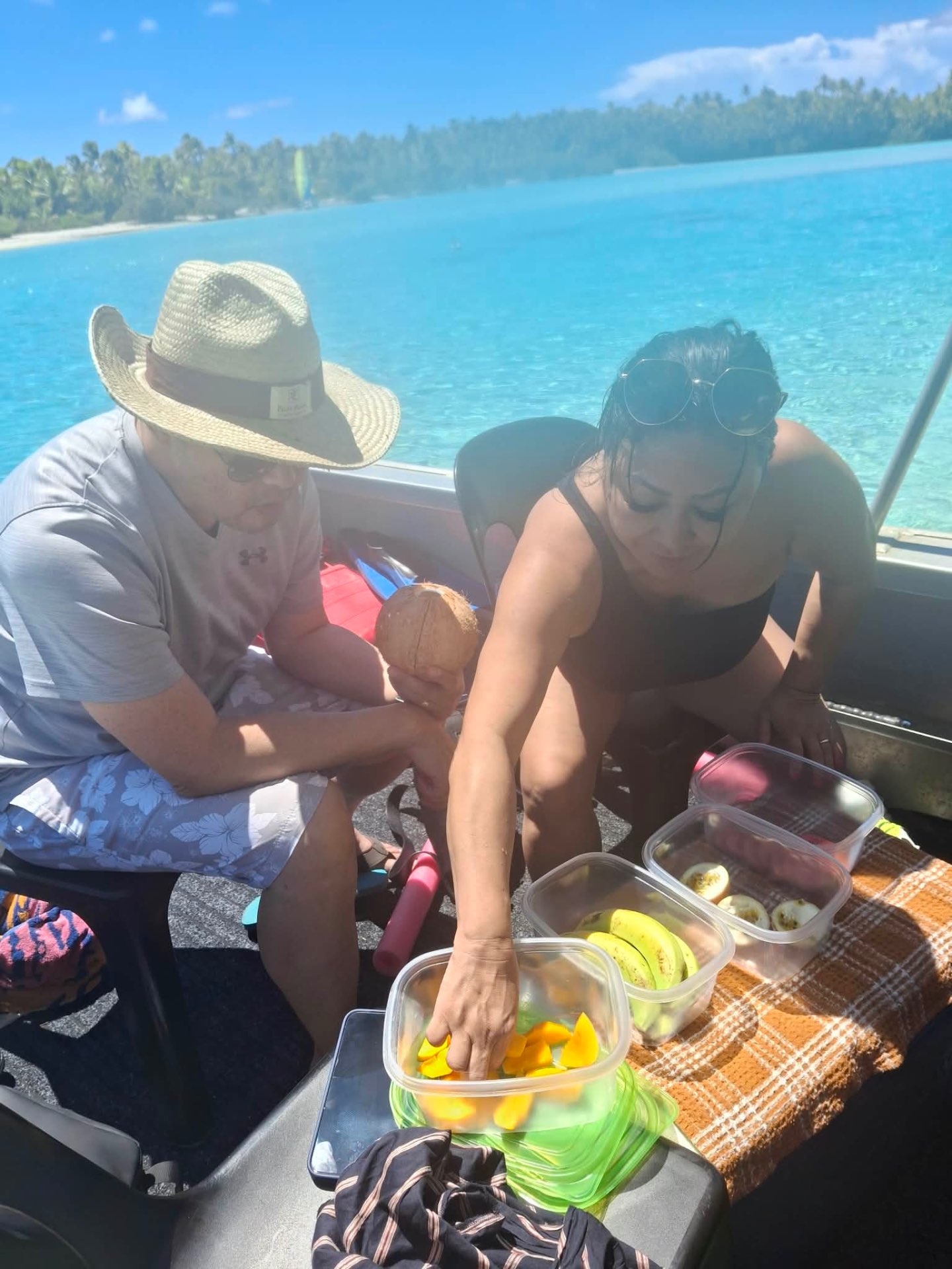 Guests enjoying fresh tropical fruit and coconut juice on the boat